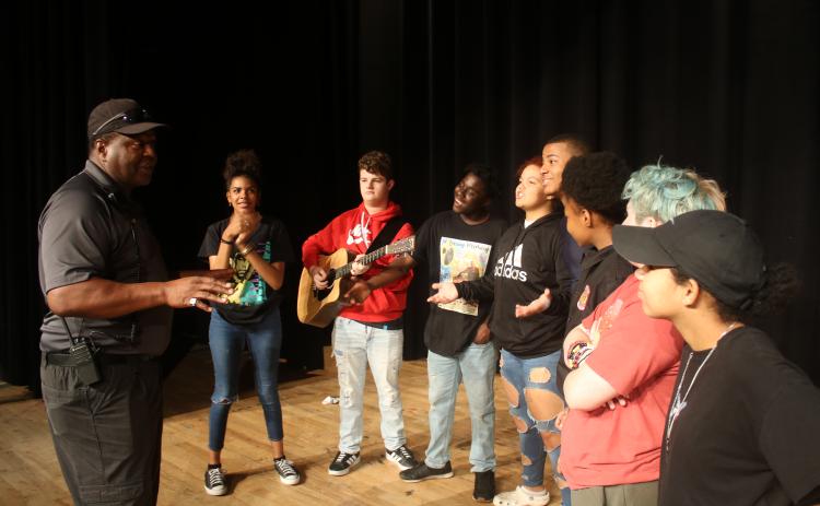 Ronnie Collins (from left), Columbia’s Top Talent competition founder and sponsor, talks to contestants Di’Amee Reese, AJ Busscher, Omarion Howard, Michelle Burch, Omarion Udell, Jacqueline Wiley, Ash Esposito and Jaleiah Burch as they prepare to compete in the first round of competition on Friday night at the Norman Choice Performing Arts Auditorium on the Columbia High School campus. (TONY BRITT/Lake City Reporter)