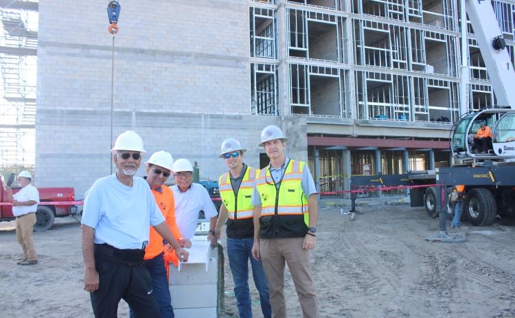 Mahendra Patel (from left), Dr. Minesh Patel and Janak Shukla stand with Jordan Gray and Todd Gray of Gray Construction during the topping-out ceremony for the Courtyard by Marriott Hotel. The Morpheus Group is the management team behind operating the new hotel, while Oasis Lake City LLC is the development group bringing the hotel to Lake City. The hotel is scheduled to open by June 2023. (TONY BRITT/Lake City Reporter)