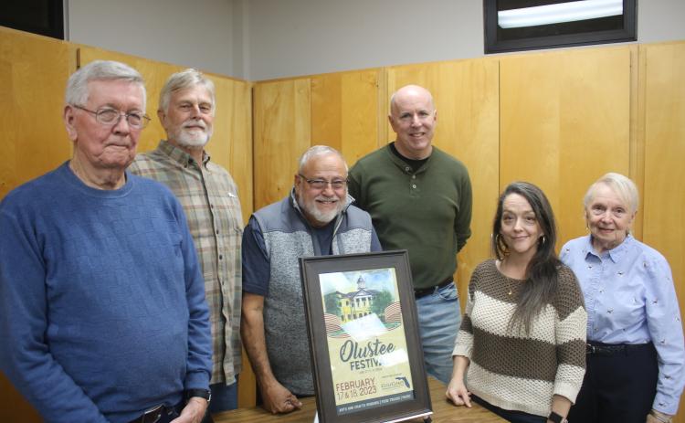 John Larner (from left) stands with members of the Blue-Grey Army Tom Coleman, Tony Buzzella, Sean McMahon, Sheila Carr (representing the Gateway Art Gallery) and Faye Bowling Warren on Tuesday night as the 44th Annual Olustee Battle Festival poster was unveiled. Larner created the painting that will be used of the event poster. (TONY BRITT/Lake City Reporter)