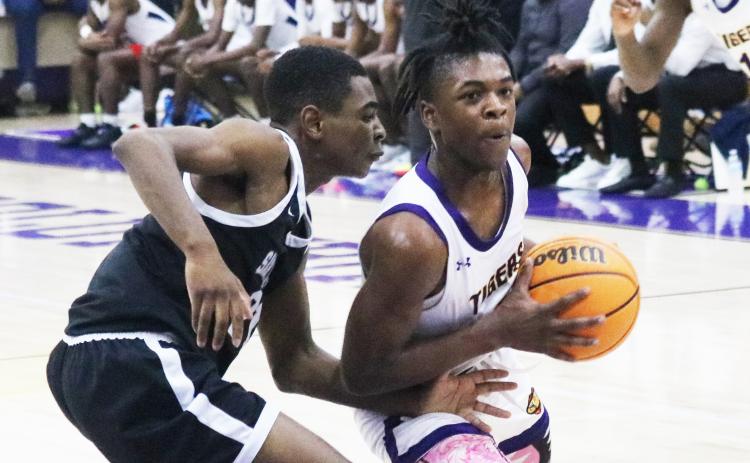 Columbia guard Zamarion Jones drives to the basket while Santa Fe guard Braylon Guyden defends on Friday night. (JORDAN KROEGER/Lake City Reporter)