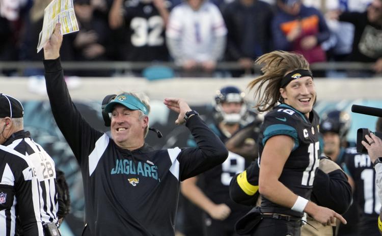 Jacksonville Jaguars head coach Doug Pederson (left) celebrates with Jacksonville Jaguars quarterback Trevor Lawrence (16) after defeating the Dallas Cowboys in overtime on Sunday in Jacksonville. (JOHN RAOUX/Associated Press)