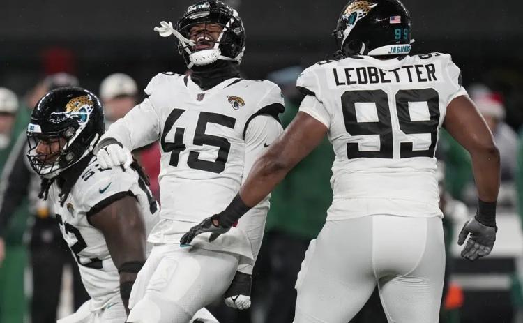 Jacksonville Jaguars linebacker K'Lavon Chaisson (45) celebrates with defensive tackle DaVon Hamilton (52) and defensive end Jeremiah Ledbetter (99) after a sack against the New York Jets on Thursday in East Rutherford, N.J. (SETH WENIG/Associated Press)