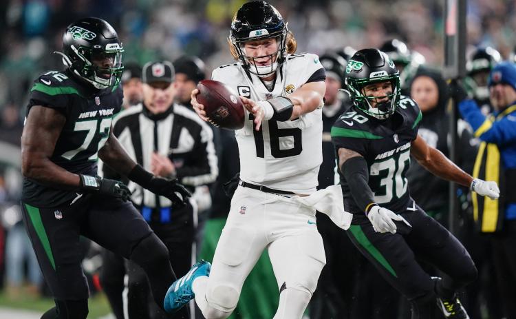 Jacksonville Jaguars quarterback Trevor Lawrence tries to get the ball across the goal line as he steps out of bounds against the New York Jets on Dec. 22 in East Rutherford, N.J. (FRANK FRANKLIN II/Associated Press)