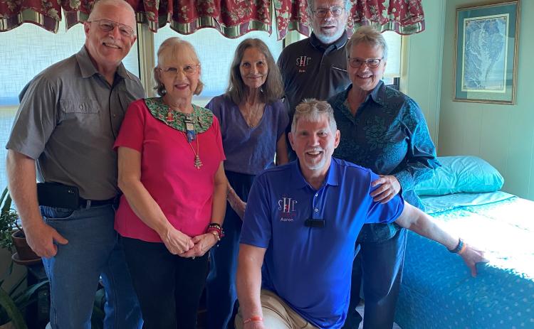 Sleep in Heavenly Peace’s Lake City chapter, including chapter co-presidents Pastor Aaron Ankeny (front on knee) and Bob Santos (back right) delivered its first bed last Saturday. (COURTESY)