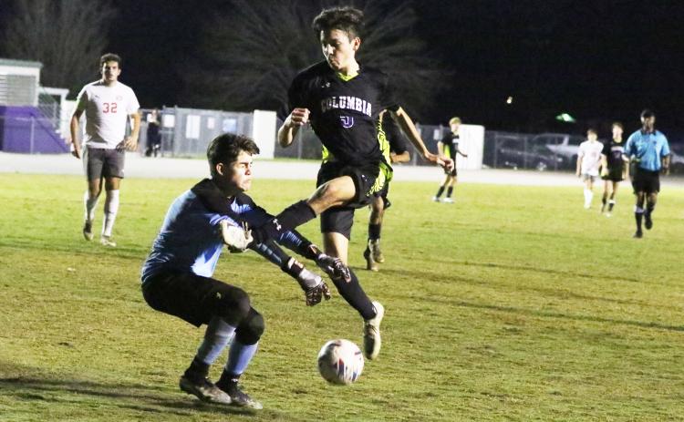 Columbia midfielder Johnathan Pineda misses on a shot in front of Santa Fe goalkeeper Rahdesh Rico Thursday night. (MORGAN MCMULLEN/Lake City Reporter)
