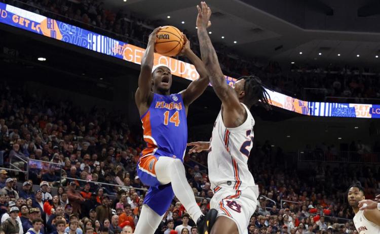 Florida guard Kowacie Reeves goes up for a shot as Auburn guard Allen Flanigan defends on Wednesday in Auburn, Ala. (BUTCH DILL/Associated Press)