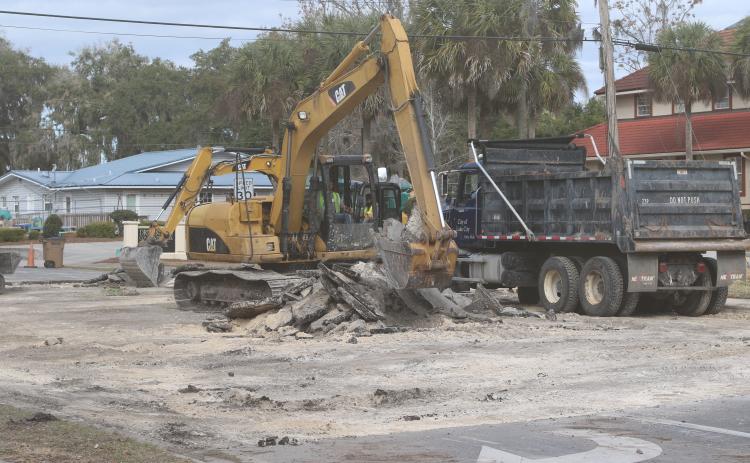 City crews clean up Lake Jeffery Road on Tuesday afternoon after repairing a broken water line on the road near the intersection with NW Orange Street. The line was broken by a contractor installing fiberoptic cables. (JAMIE WACHTER/Lake City Reporter)