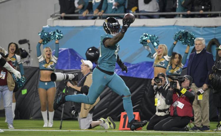 Jacksonville Jaguars linebacker Josh Allen returns a fumble for the game-winning touchdown against the Tennessee Titans on Saturday in Jacksonville. (PHELAN M. EBENHACK/Associated Press)