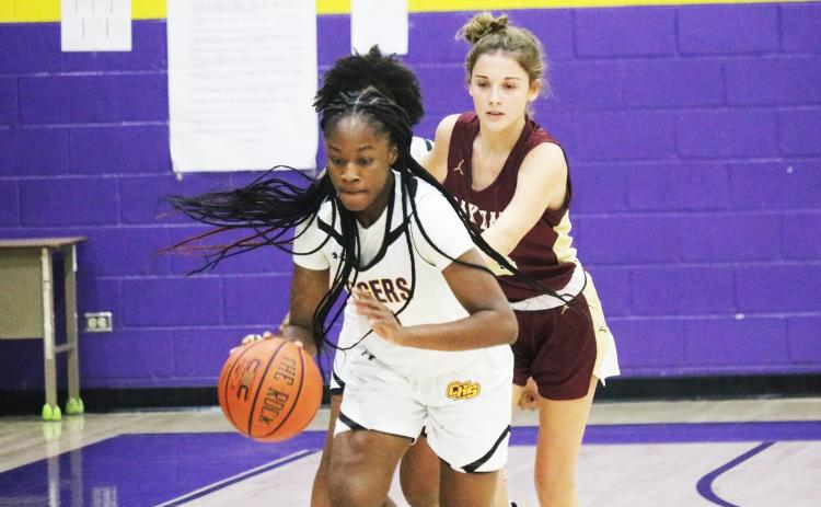 Columbia guard Eriel Baker pushes the ball up the court after stealing it away from Oak Hall guard Bella Gloriod on Friday night. (JORDAN KROEGER/Lake City Reporter)