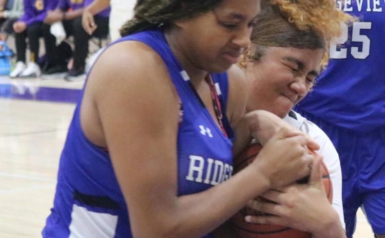 Columbia center Khalea Clark fights for possession for the basketball with Ridgeview forward Nacoya Blocton during Monday night’s game. (JORDAN KROEGER/Lake City Reporter)