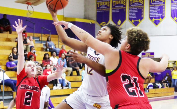 Columbia forward Jolena Gardner rises between Middleburg defenders Ruby Owen (2) and Cheyenne Jenkins (21) during Tuesday night’s District 2-5A quarterfinal. (BRENT KUYKENDALL/Lake City Reporter)