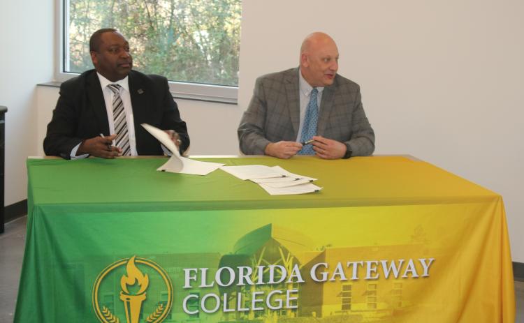 Florida Gateway College President Lawrence Barrett (right) and Santa Fe College President Paul Broadie II signed five articulation agreements Friday that will allow students at the colleges to continue their education at the other institution. (TONY BRITT/Lake City Reporter)