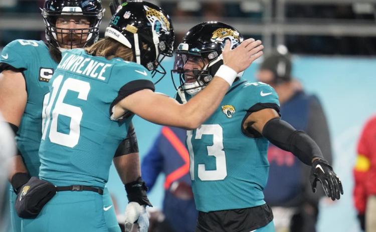 Jacksonville Jaguars wide receiver Christian Kirk (13) celebrates his touchdown reception with quarterback Trevor Lawrence (16) during Saturday's game against the Tennessee Titans in Jacksonville. (JOHN RAOUX/Associated Press)