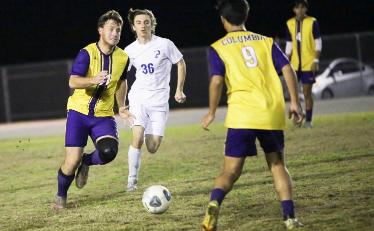 Columbia’s Mickey Johnson (11) passes to teammate Bryson Kyi (9) during Tuesday’s match against Palatka. (BRENT KUYKENDALL/Lake City Reporter)