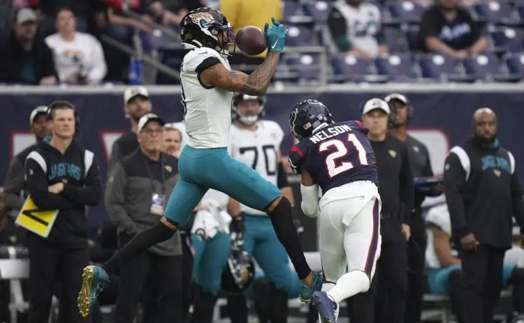 Jacksonville Jaguars wide receiver Marvin Jones Jr. (11) makes a catch over Houston Texans cornerback Steven Nelson (21) on Sunday in Houston. (ERIC CHRISTIAN SMITH/Associated Press)