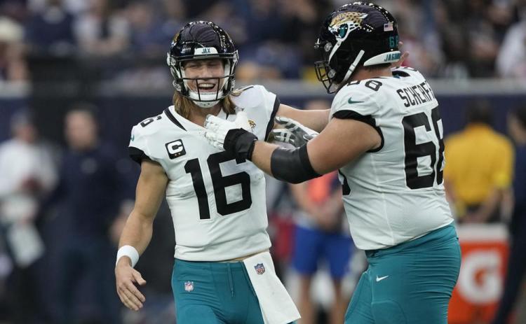 Jacksonville Jaguars quarterback Trevor Lawrence (16) and guard Brandon Scherff (68) celebrate a touchdown against the Houston Texans on Sunday in Houston. (DAVID J. PHILLIP/Associated Press)