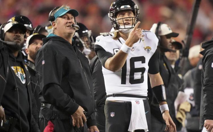 Jacksonville Jaguars quarterback Trevor Lawrence speaks with Jacksonville Jaguars head coach Doug Pederson during Saturday's divisional round playoff game against the Kansas City Chiefs in Kansas City, Mo. (CHARLIE RIEDEL/Associated Press)