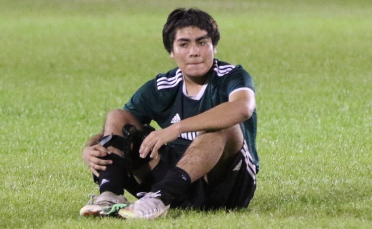 Suwannee’s Kendal Vasquez-Hernandez sits on the field dejected after the Bulldogs lost to Eastside 2-0 in the District 2-4A championship on Tuesday night. (MORGAN MCMULLEN/Lake City Reporter)