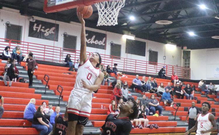Fort White guard Tafari Moe rises for a layup over Lafayette’s Amarie Fleming on Friday night. (MORGAN MCMULLEN/Lake City Reporter)
