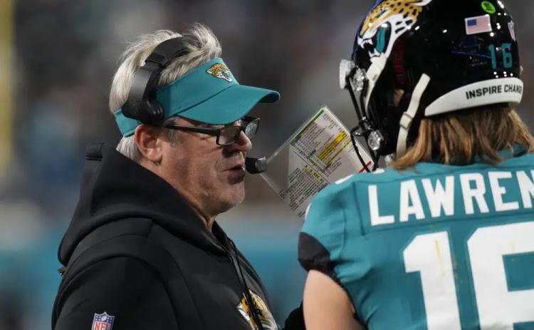 Jacksonville Jaguars head coach Doug Pederson (left) speaks to Jacksonville Jaguars quarterback Trevor Lawrence on the sidelines during last Saturday's wild-card playoff game against the Los Angeles Chargers in Jacksonville. (CHRIS O'MEARA/Associated Press)