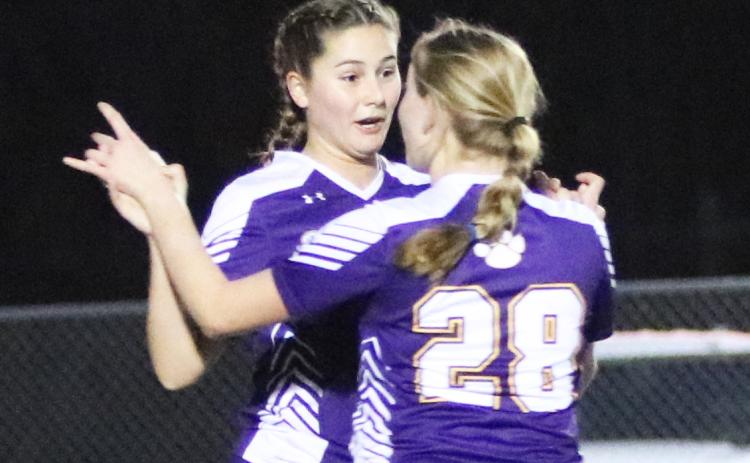 Columbia Sydney Rivas (31) celebrates with Kyndall Norris (28) after Rivas’ first of two goals against Trinity Catholic on Wednesday night. (JORDAN KROEGER/Lake City Reporter)
