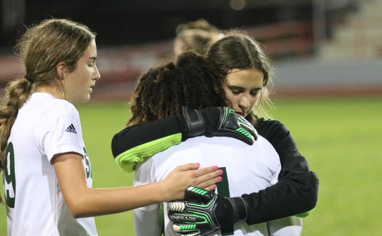Suwannee goalkeeper Layla Merola hugs and consoles Alaira Handy following the Bulldogs’ 2-1 loss to Santa Fe in the District 2-4A championship on Monday night. (JORDAN KROEGER/Lake City Reporter)