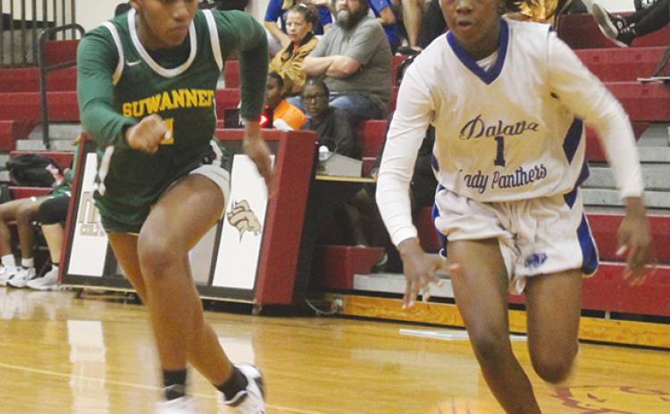 Palatka’s Jhane Fountain finds an alley to the basket as Suwannee’s Janeah Mitchell tries to keep up with her in Thursday night’s District 5-4A semifinal. (MARK BLUMENTHAL/Palatka Daily News)
