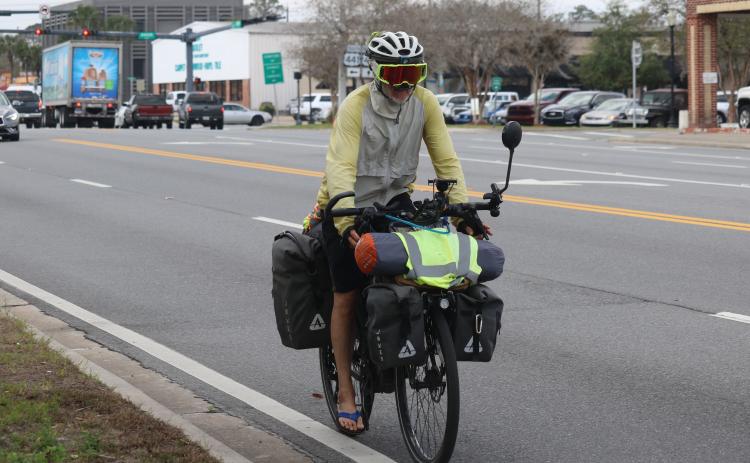 Paul Webb rides down E. Duval Street in Lake City on his way to Jacksonville during his cross-country bicycle ride to raise funds for the Challenged Athletes Foundation. (JAMIE WACHTER/Lake City Reporter)