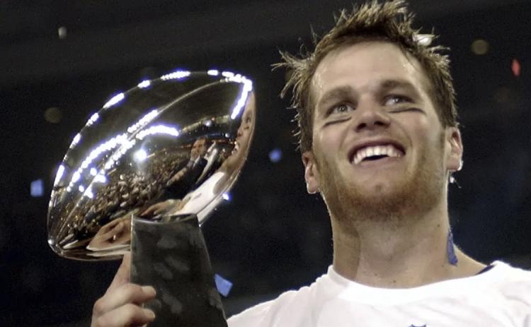 New England Patriots quarterback Tom Brady holds the Vince Lombardi Trophy after the Patriots beat the Carolina Panthers 32-29 in Super Bowl 38 on Feb. 1, 2004, in Houston. (AP FILE)