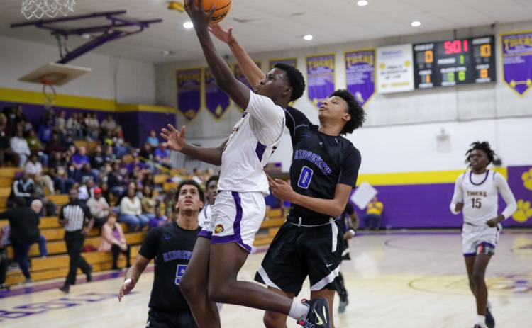 Columbia guard Isaac Broxey drives past Ridgeview’s Calen Wiggins for a layup Wednesday night in a District 2-5A tournament semifinal. (BRENT KUYKENDALL/Lake City Reporter)