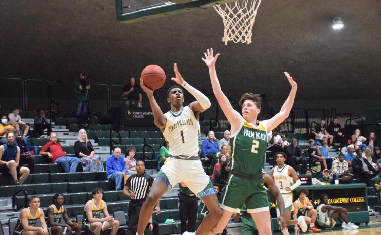 FGC guard Jeremiah Barze goes up for a shot while being defended by Palm Beach State College guard Ryan Moore on Wednesday at the Howard Center. (COURTESY OF FGC)