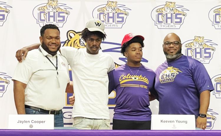 Columbia running back/receiver Jaylen Cooper (center left) and receiver Keeven Young (center right) signed letters of intent on Monday to play collegiately. Cooper is headed to Warner, while Young will play at Carthage. The duo are pictured alongside assistant coaches Anthony Newton (left) and Al Nelson (right). (COURTESY)