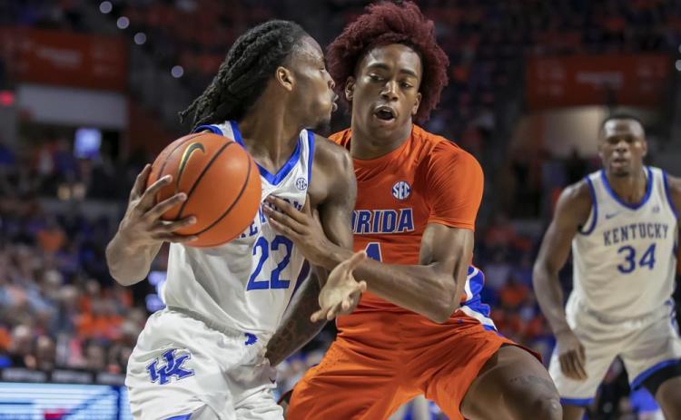 Kentucky guard Cason Wallace drives against Florida guard Niels Lane on Wednesday in Gainesville. (ALAN YOUNGBLOOD/Associated Press)