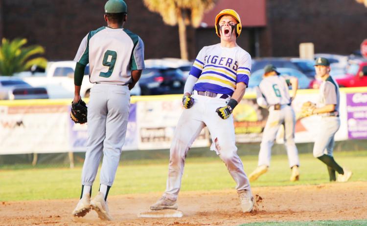 Columbia catcher Hayden Gustavson celebrates at second base after hitting a double against Lincoln  during last season’s Region 1-5A championship. (BRENT KUYKENDALL/Lake City Reporter)