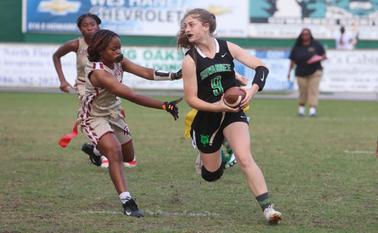 Suwannee quarterback Maci Campbell scrambles away from pressure against Florida High last season. (PAUL BUCHANAN/Special to the Reporter)