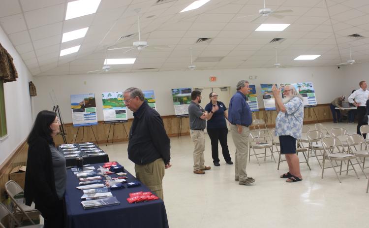 Barbara Cartwright (left), with the Florida Division of Emergency Management, talks to Mike Null during a meeting regarding new FEMA flood maps on Thursday night at the Westside Community Center. (TONY BRITT/Lake City Reporter)