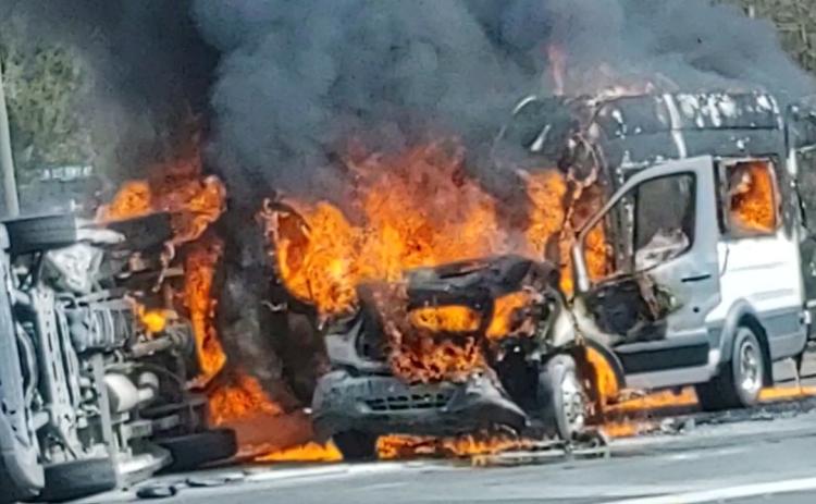 Two vans burst into flames after colliding on U.S. Highway 41 North at the intersection with NW Moore Road on Wednesday afternoon. (COURTESY)