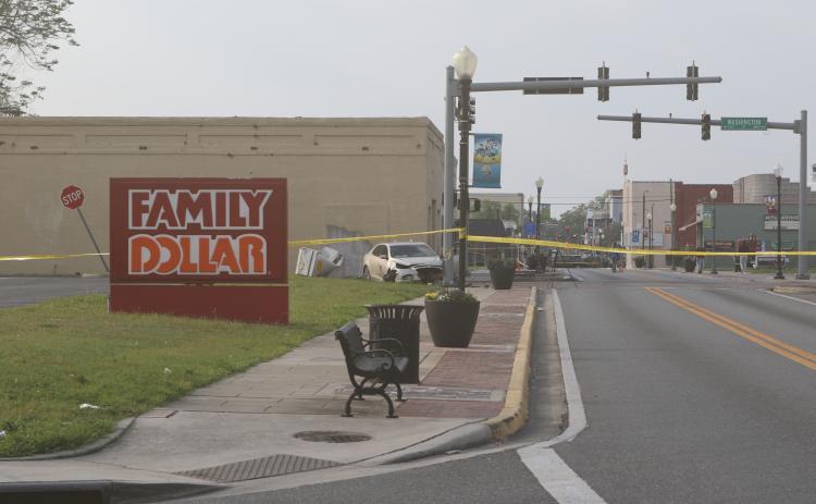A car crashed through a traffic signal control box before slamming into the traffic signal early Friday morning. A passenger was seriously injured and the roadway was closed for hours. (JAMIE WACHTER/Lake City Reporter)
