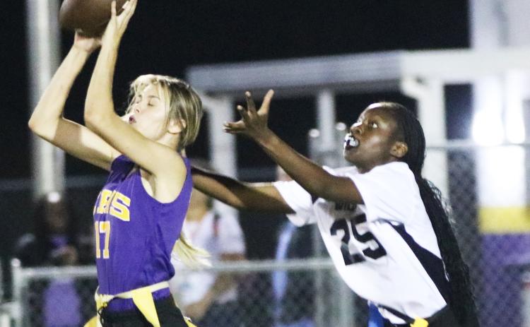 Columbia safety Mia Brasel intercepts her third pass of the night in front of Baker County receiver Samuriah Major on Thursday night. (JORDAN KROEGER/Lake City Reporter)