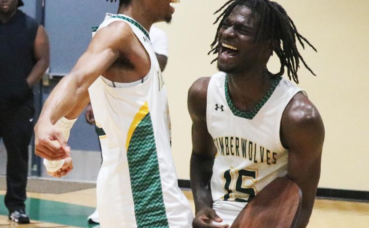 FGC guards Jeremy Young (left) and Maurice Campbell (right) celebrate after defeating Pitt CC in the South Atlantic District B championship on Saturday. (JORDAN KROEGER/Lake City Reporter)
