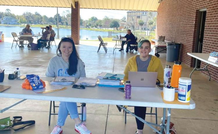 Volunteers sit at a makeshift desk at Wilson Park during a Florida drivers license restoration event in 2022. (COURTESY)