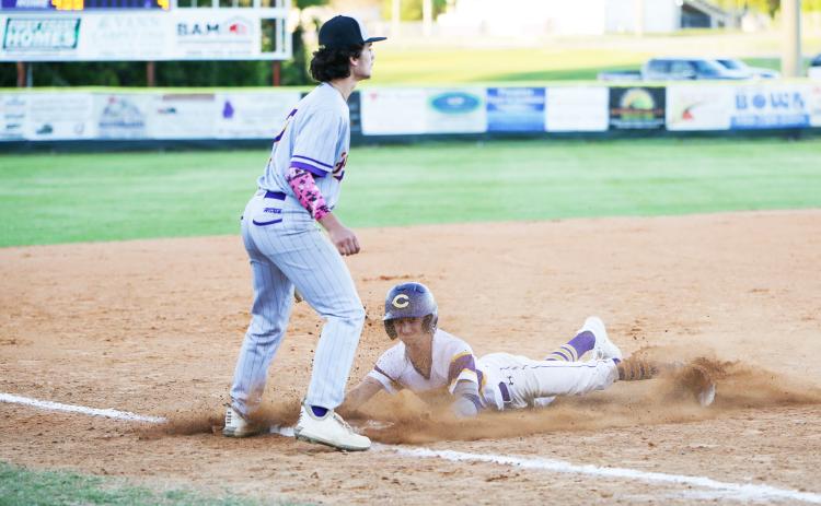 Columbia’s Matt Dumas slides safely into third base against Lake Weir on Wednesday night. (BRENT KUYKENDALL/Lake City Reporter)