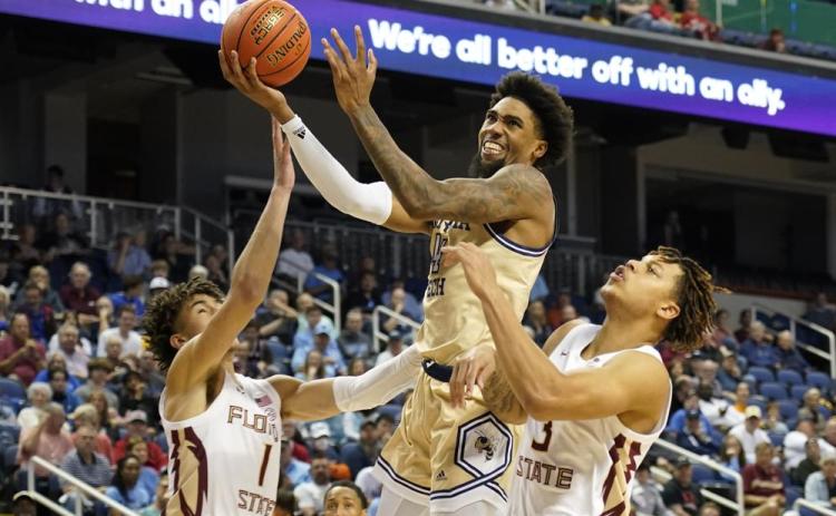 Georgia Tech forward Javon Franklin drives between Florida State guards Jalen Warley (1) and Cam Corhen (3) during an ACC tournament game on Tuesday in Greensboro, N.C. (CHUCK BARTON/Associated Press)