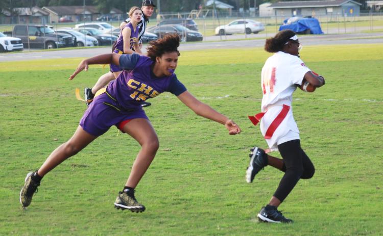 Columbia’s Jolena Gardner misses the flag of Florida High’s Danielle White on Thursday night. (JORDAN KROEGER/Lake City Reporter)