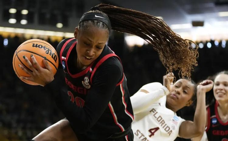 Georgia forward Jordan Isaacs grabs a rebound in front of Florida State guard Sara Bejedi during a first-round game in the NCAA tournament on Friday in Iowa City, Iowa. (CHARLIE NEIBERGALL/Associated Press)