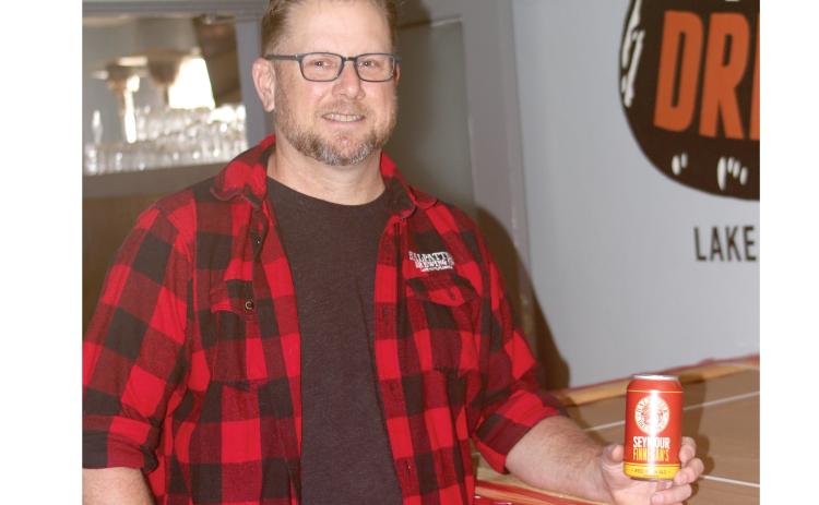 Chris Candler, co-owner of Halpatter Brewing Company, holds one of the cans of Seymour Finnegan’s, the brewery’s first cans set for distribution. (JAMIE WACHTER/Lake City Reporter)