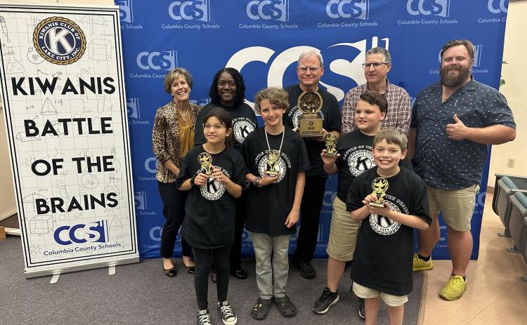 Fort White Elementary School won the 2023 Kiwanis Battle of the Brains on Thursday. Team members, in front, include Sarah Rafael (from left), Wyatt Chism,Tucker Ayers and Brayden Blalock. They are joined in back by Stephanie Lunde, Dr. Marilyn Gassett, Alan Gatzke, John Kasak, and James Carter, the president of Lake City Kiwanis Club. (COURTESY)