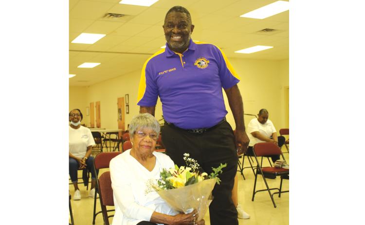 TONY BRITT/Lake City Reporter Francena Robinson Harris,103, holds a bouquet of flowers presented by Rev. Kyle Gibson, who recently visited the Olivet Missionary Baptist Church Health and Wellness group following one of its exercise classes. (TONY BRITT/Lake City Reporter)