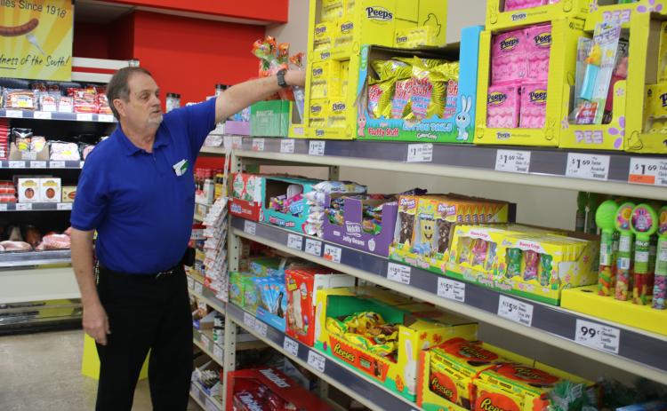 David Strickland, a manager at Save A Lot in Lake City, arranges Easter inventory on the store’s shelves on Thursday afternoon. Strickland retired Thursday after working at the store for 47 years. (TONY BRITT/Lake City Reporter)