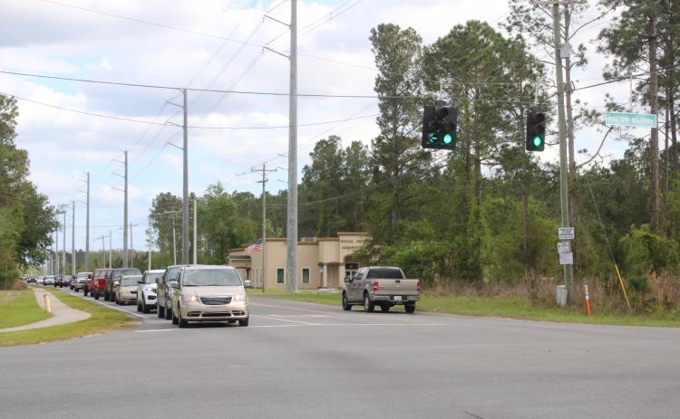 Cars sit at the intersection of Sisters Welcome Road and Bascom Norris Drive on Friday. (TONY BRITT/Lake City Reporter)